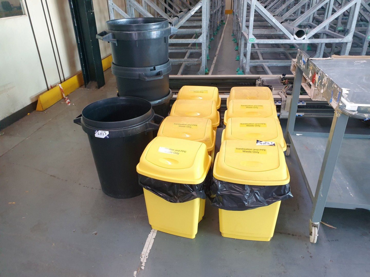 4x black plastic rubbish bins, 8x yellow sanitary...