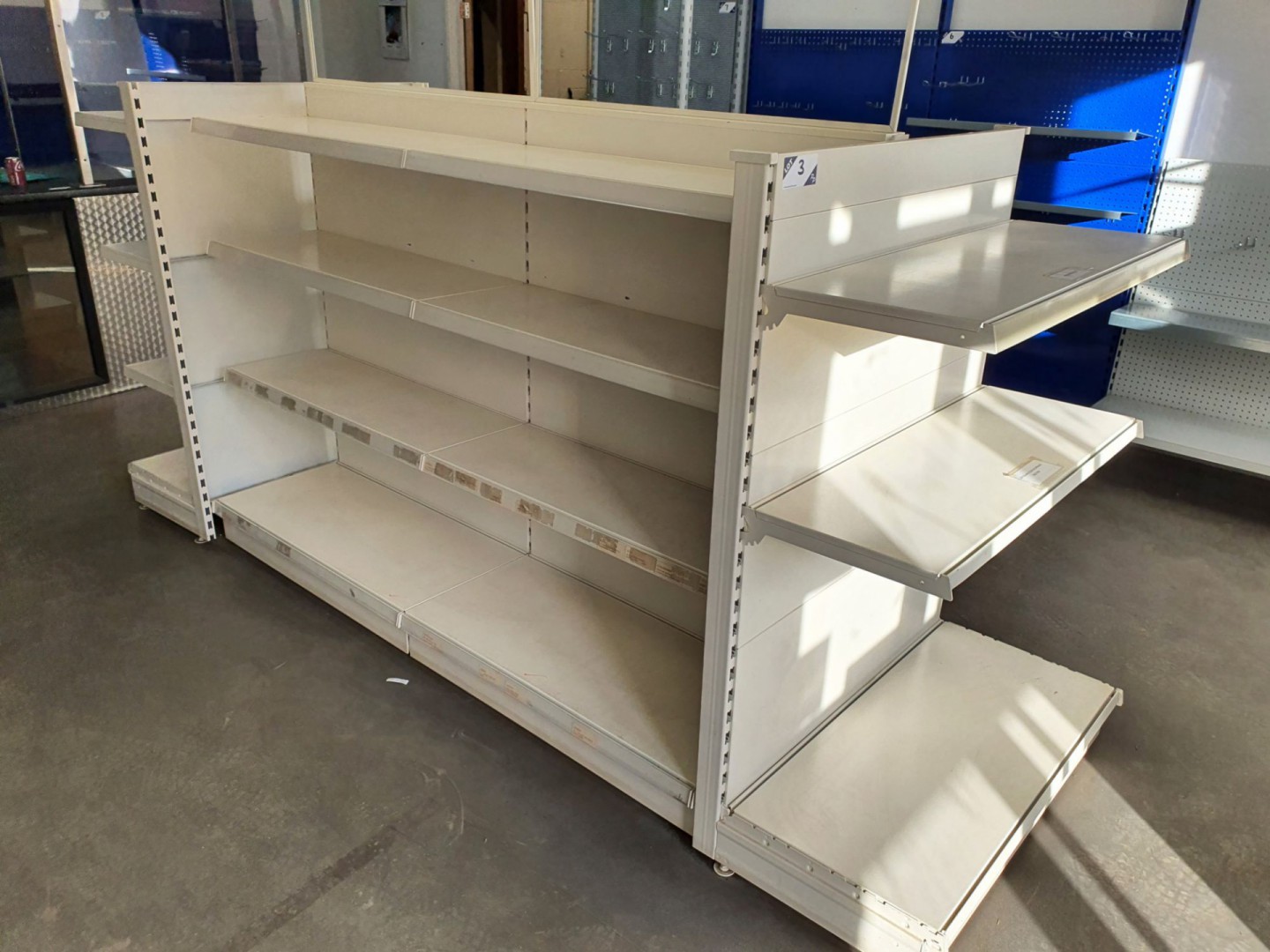 Cream metal freestanding multishelf storage displa...
