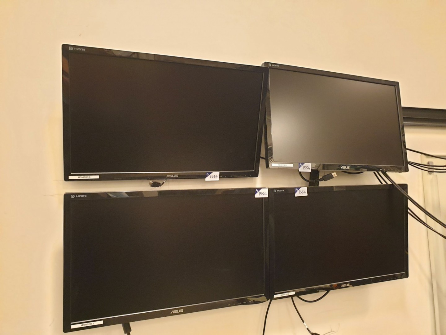 4x Asus LCD monitors on wall brackets