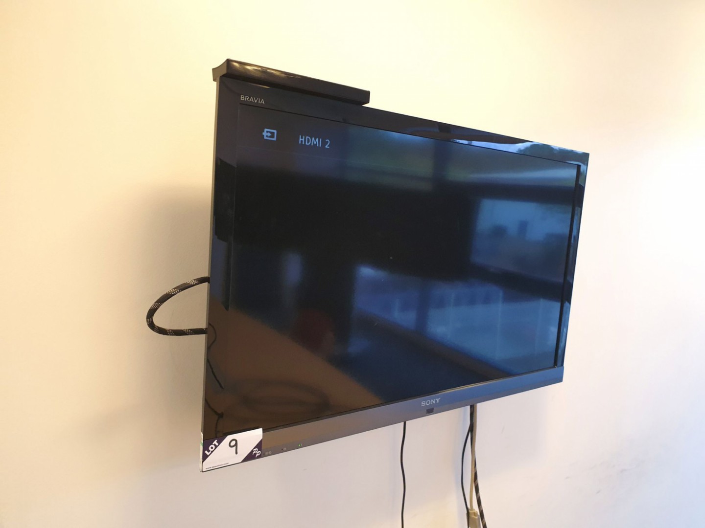 Sony Bravia 40" LCD TV on wall bracket with remote