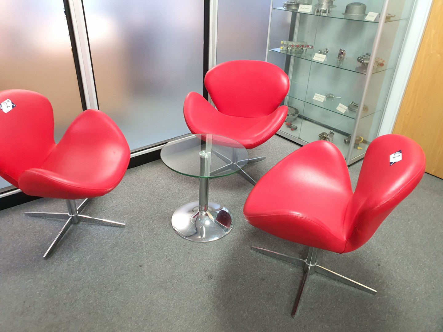 3x red leather reception chairs & glass top table,...